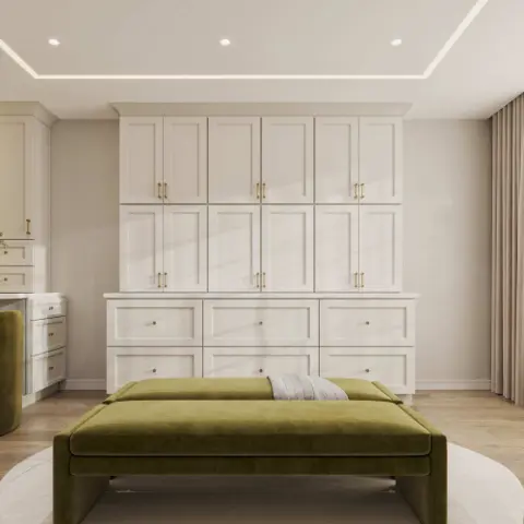 Floor-to-ceiling white built-in cabinets and drawers behind a green upholstered bench